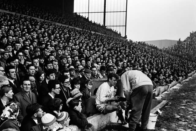 Billy Bremer changes his boots at Elland Road in 1965. PIC: Varley Picture Agency