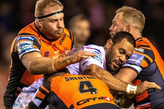 Wakefield's Bill Tupou is held by Castleford's Oliver Holmes, Paul McShane and Michael Shenton. Picture: Bruce Rollinson.