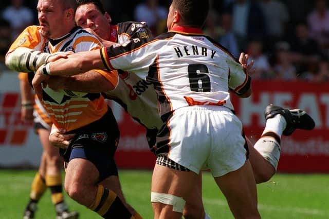 Castleford Tigers captain Adrian Vowles breaks past Henry Paul of Bradford Bulls. Picture by Mark Bickerdike.