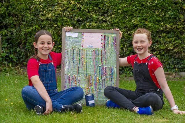 Sisters Indie, nine and Esmee, 11, with their bracelets. Picture Tony Johnson