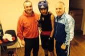 Fighting fit: Khalid Ayub flanked by his trainers is set to step up from the amateur ranks to the professional boxing game.