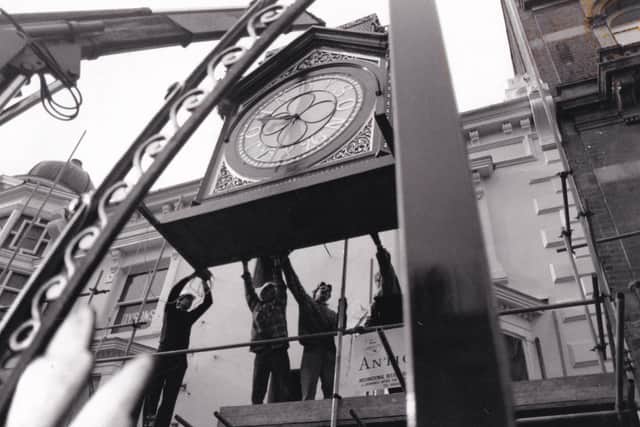 The Dyson's clocks were hoisted back into position by a crane after two years of careful restoration work.