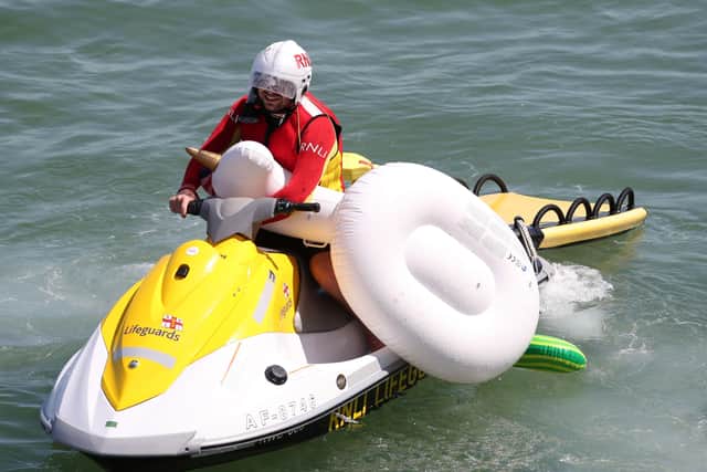 An RNLI lifeguard patrols the South Coast.