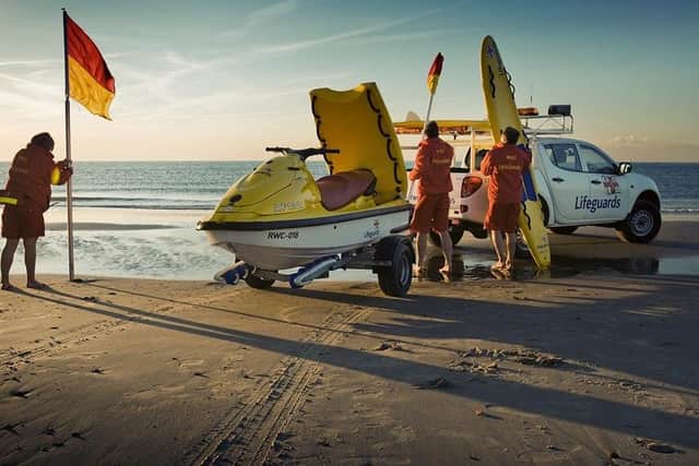 RNLI lifeguards on a beach.