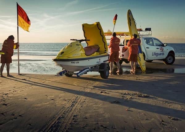RNLI lifeguards on a beach.