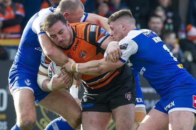 Grant Millington is tackled by St Helens' James Roby and Morgan Knowles in Castleford's last game before Super League was shut down. Picture by Tony Johnson.