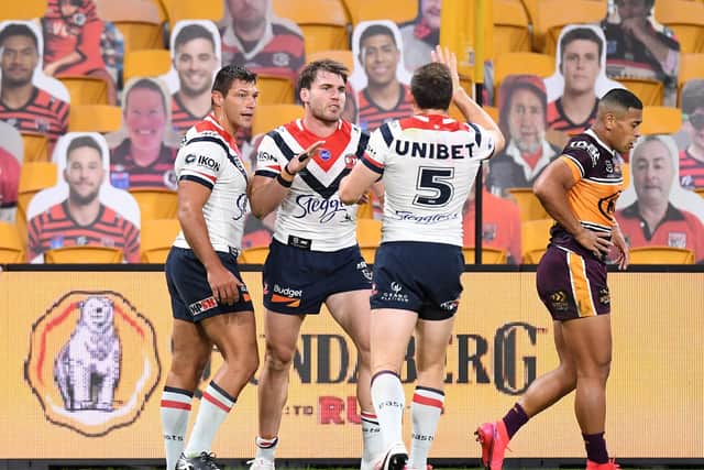 Back in action: Ryan Hall, left, with Angus Crichton celebrating a try for Sydney Roosters against Brisbane Broncos in front of cardboard cut-outs at Suncorp Stadium. Picture: Bradley Kanaris/Getty Images