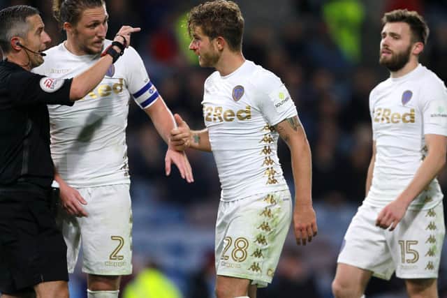 SOLID: Leeds United defender Gaetano Berardi, centre, has words with referee Darren Bond with a cut on his eye during the Carabao Cup clash at Burnley in September 2017. Picture by Richard Sellers/PA Wire.