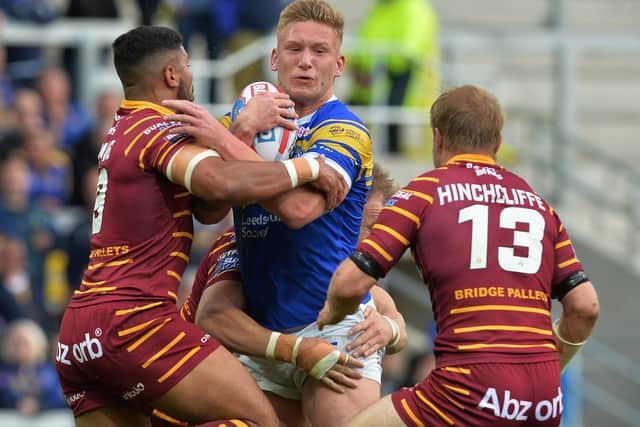 Mikolaj Oledzki is held by Kruise Leeming and Ryan Hinchcliffe during the clash between 
Leeds Rhinos and Huddersfield Giants on this day in 2018. Picture: Bruce Rollinson.