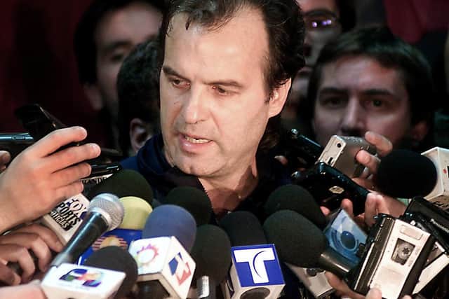 INQUEST: Marcelo Bielsa faces an unexpected press conference upon his arrival at the airport in Buenos Aires following Argentina's exit from the 2002 World Cup. Photo by FABIAN GREDILLAS/AFP via Getty Images.