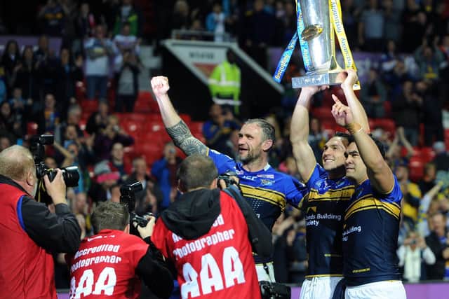 Jamie Peacock, Kevin Sinfield and Kylie Leuluai with the Super League trophy at Old Trafford in 2015.  Picture by Jonathan Gawthorpe.