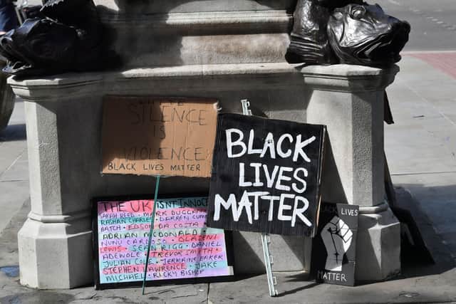 Signs by the empty plinth where the statue of Edward Colston in Bristol once stood after it was taken down during a Black Lives Matter protest on Sunday. The protests were sparked by the death of George Floyd, who was killed on May 25 while in police custody in the US city of Minneapolis.