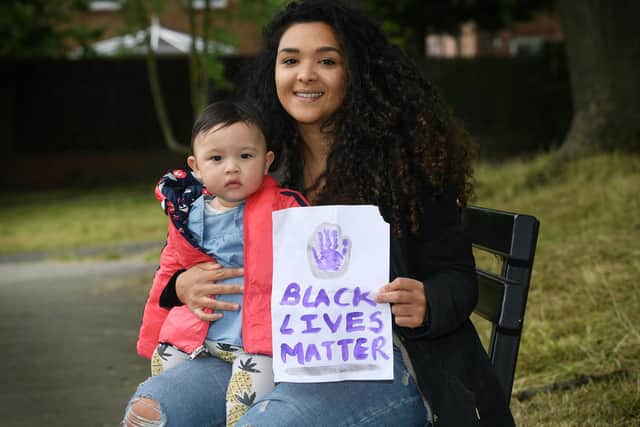 Jessica O'Shea, pictured with daughter Aida, faced abuse after putting this homemade Black Lives Matter poster in the window of her Leeds home - but her faith in people was restored when many in the community rallied behind her to display copies in their own windows. Picture: Jonathan Gawthorpe