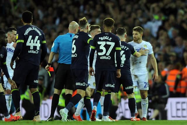 HEATED: Leeds United's Gaetano Berardi is surrounded after being sent off against Derby. Photo by Tony Johnson.