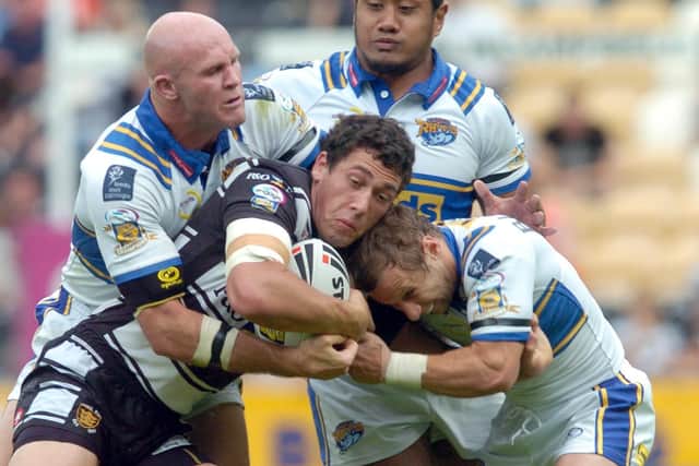 Strong defence from Rhinos' Keith Senior, Ali Lauitiiti and Rob Burrow. Picture  by James Hardisty.