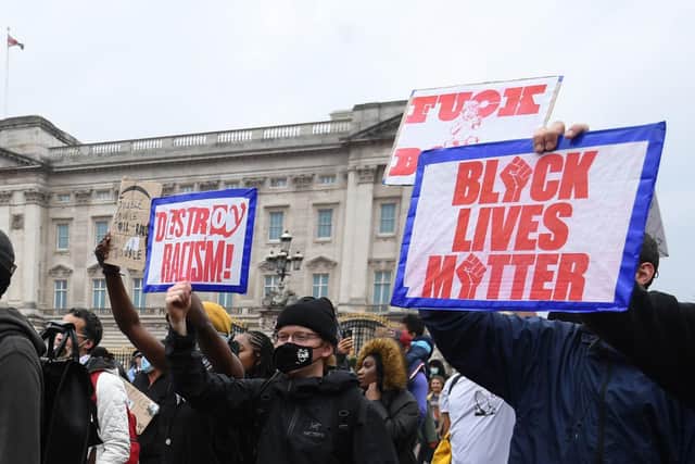 People walk past Buckingham Palace during a Black Lives Matter protest march in London. PA Photo