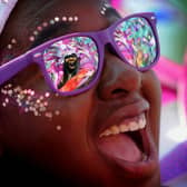 Leeds Carnival Queen Tahiela Odain Hamilton is reflected in the glasses of Eleanor Claxton at last yea's Leeds West Indian Carnival..Picture by Simon Hulme