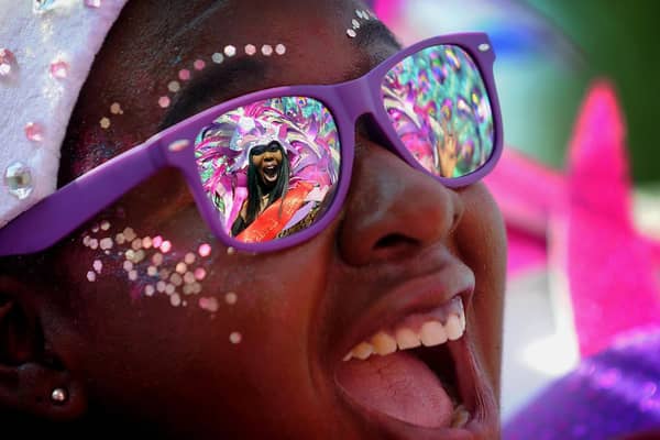 Leeds Carnival Queen Tahiela Odain Hamilton is reflected in the glasses of Eleanor Claxton at last yea's Leeds West Indian Carnival..Picture by Simon Hulme