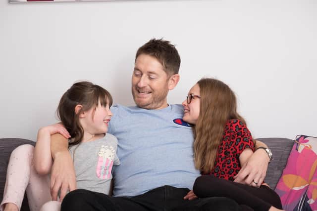 Lloyd Pinder pictured with his two daughters - Gracie, 11, and Lola, seven