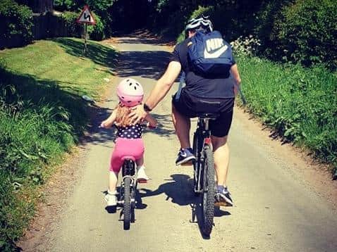 Penny Gladman being given a helping hand by dad Gareth on her cycle challenge.