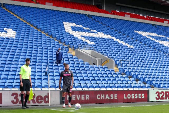 NEW NORMAL - Kalvin Phillips takes a corner for Leeds United in front of an almost entirely empty stand at the Cardiff City Stadium. Pic: PA