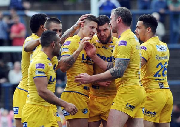 Liam Sutcliffe is congratulated after kicking a last-minute penalty to earn Leeds Rhinos a 32-31 victory over Catalans Dragons in 2014. Picture: Steve Riding.