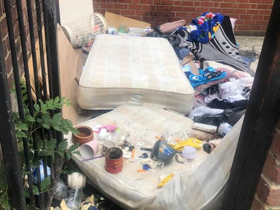 Mattresses and other rubbish dumped in a yard in Harehills