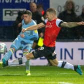 TOUGHING IT OUT: Leeds United's Pablo Hernandez fires in a cross under pressure from Matty Pearson in November's clash at Luton Town. The Whites needed a late Pearson own goal to ensure a 2-1 victory. Picture Bruce Rollinson