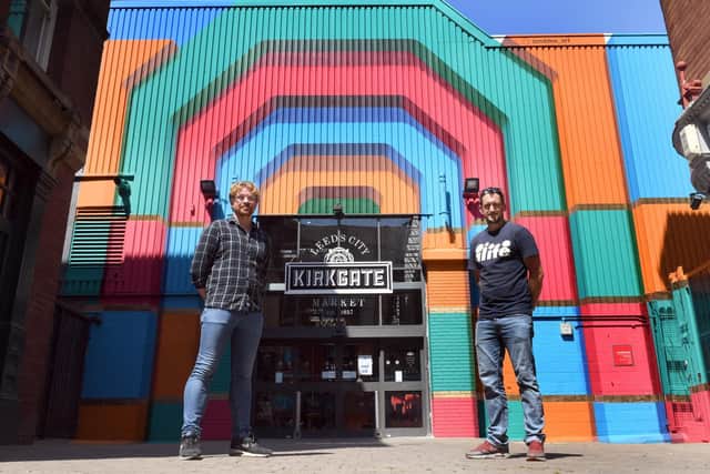 Coun Jonathan Pryor from Leeds City Council (left) with artist Rob Lee and  his artwork outside Kirkgate Market in Leeds.