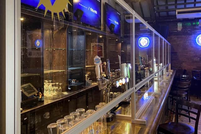 Protective bar screens will greet customers in Brotherhood this weekend.