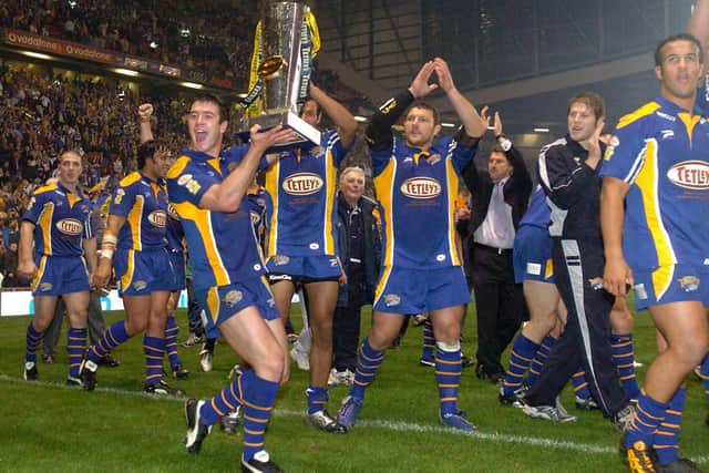 Richie Mathers shows off the trophy during Rhinos' lap of honour after the 2004 Grand Final. Picture by Steve Riding.