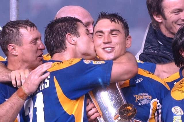 Richie Mathers celebrates with captain Kevin Sinfield following the trophy presentation. Picture by Steve Riding.