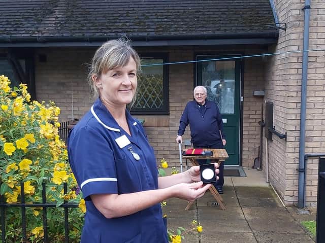 Therese  Dales,associate community matron at Leeds Community Healthcare NHS Trust is picturedf with one of the medals asWilliam Wheatley looks on.