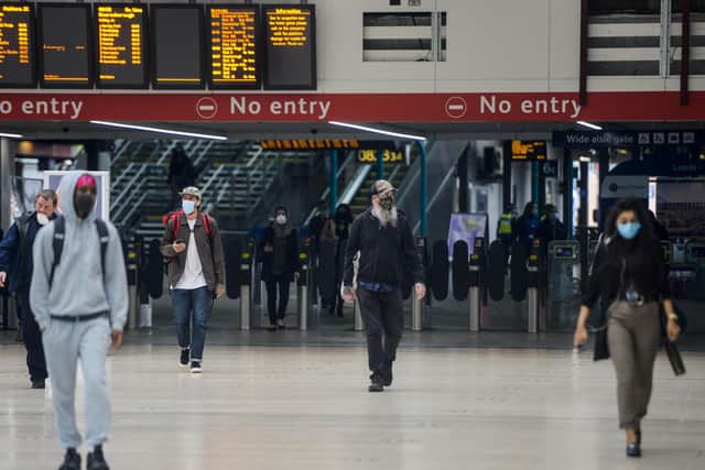 Commuters wearing face coverings arrive in Leeds.