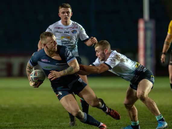Featherstone Rovers' Ben Blackmore is tackled by Leeds Rhinos' Jarrod O'Connor during a pre-season game in January. Picture by Bruce Rollinson.