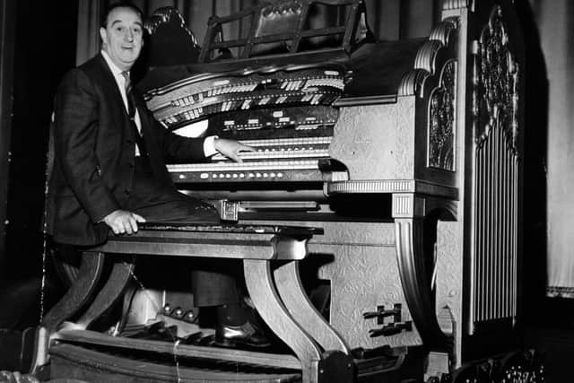 Arnold Loxam seated at the Wurlitzer organ in the Odeon Cinema.