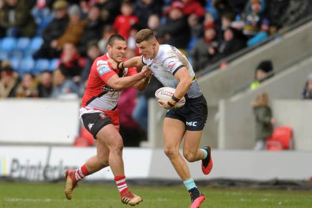 Ash Handley evades former teammate Tui Lolohea during Rhinos' win at Salford in February. Picture by Steve Riding