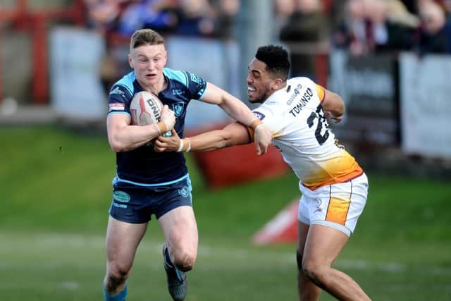 Playing for Featherstone in 2018, Harry Newman takes on Batley's Keenan Tomlinson. Picture by Jonathan Gawthorpe.