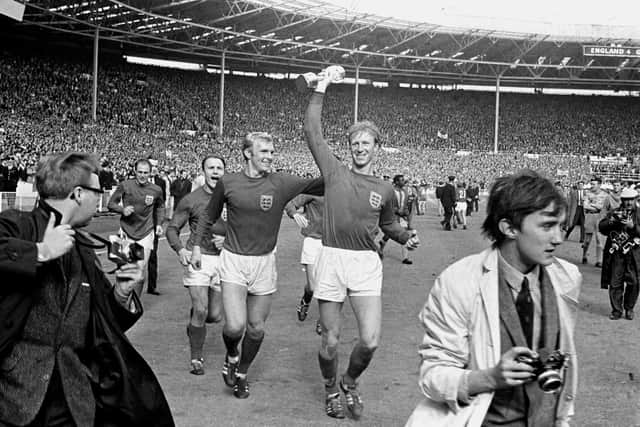 LEGEND: England's Jack Charlton holds the Jules Rimet trophy aloft as he parades it around Wembley with team-mates Ray Wilson, George Cohen and Bobby Moore following their 4-2 win over West Germany. Picture: PA.
