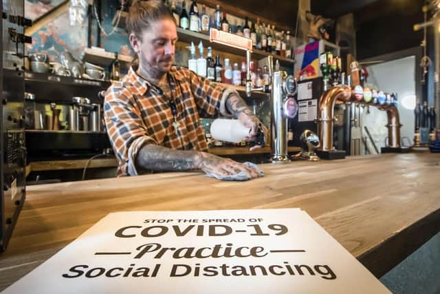 Stuart Dixon cleaning up at the Doghouse Bar in Leeds. Picture: Danny Lawson/PA Wire