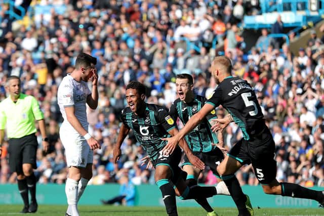 SICKENER: Leeds United winger Jack Harrison shows his disappointment as Wayne Routledge and his Swansea City team-mates celebrate Routledge's late winner in August's triumph at Elland Road. Picture by Richard Sellers/PA Wire.