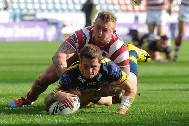 Zak Hardaker touches down to score for Leeds Rhinos as Josh Charnley challenges in vain during the 2012 Carnegie Challenge Cup semi-final. Picture: Steve Riding.