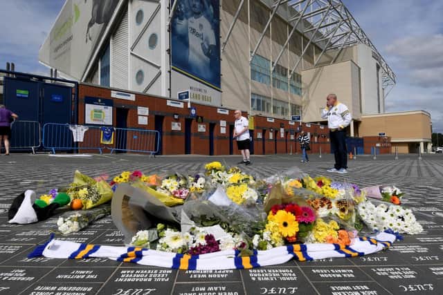Fans gather outside Elland Road to leave messages and tributes.