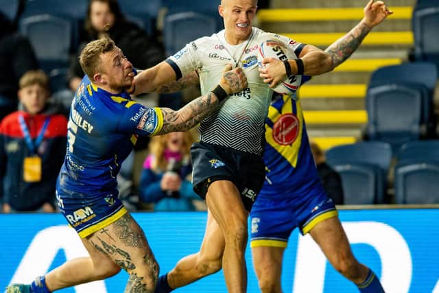 Ash Handley takes on Warrington's Josh Charnley. Picture by Bruce Rollinson.
