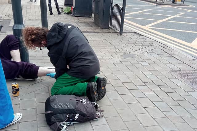 Dominic Maddocks treats a patient in the city centre.