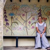 Artist Kim Coley with her bus stop mural. Photo: Ernesto Rogata