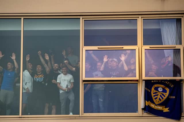 SCENES - Leeds United's squad salute their fans from the windows of Elland Road after promotion to the Premier League was secured. Pic: Bruce Rollinson