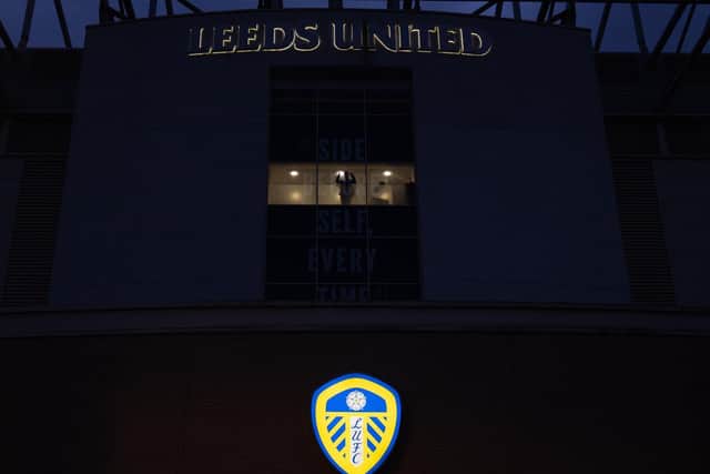 A lone person celebrates in an office at Leeds United's Elland Road after promotion on Friday.