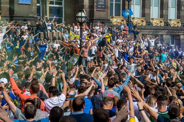 Crowds gather to celebrate after Leeds United's victory over Derby County