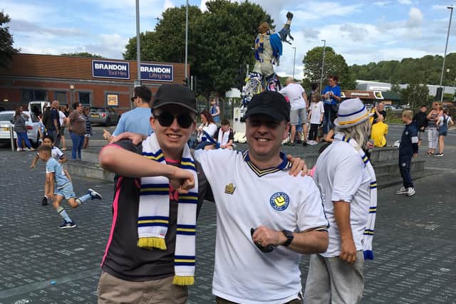 George (left) and Jon Laycock join in the Leeds United promotion celebrations outside Elland Road